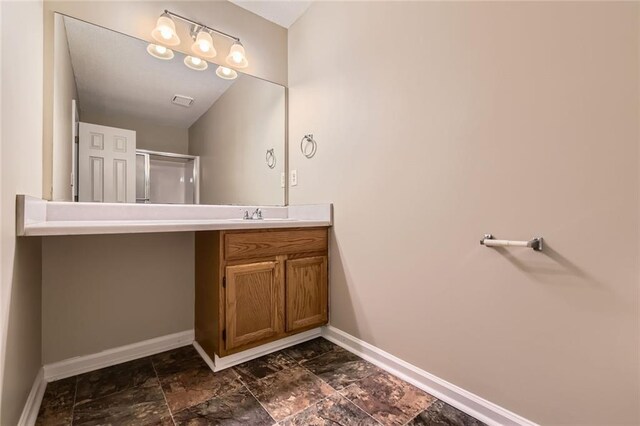 62 Sweetwater Pkwy, Powder Springs, GA 30127 - bathroom with baseboards, vanity, a shower with shower door, and stone finish floors