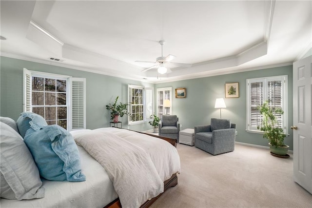 bedroom featuring a raised ceiling, light carpet, visible vents, and crown molding