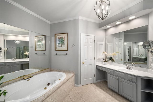 bathroom featuring a tub with jets, an inviting chandelier, tile patterned flooring, and a sink