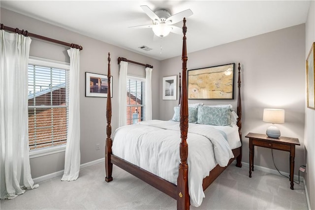 carpeted bedroom with baseboards, visible vents, and a ceiling fan