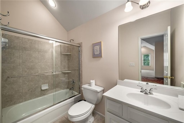 bathroom with toilet, vaulted ceiling, vanity, and combined bath / shower with glass door