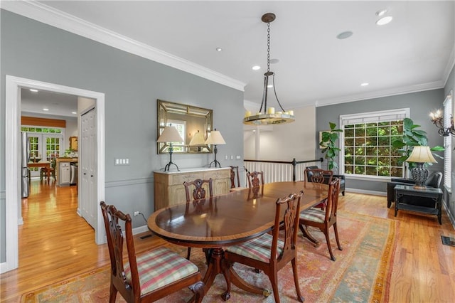 dining room featuring recessed lighting, light wood finished floors, and crown molding