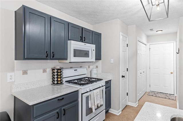 kitchen featuring white appliances, blue cabinetry, light tile patterned flooring, and backsplash