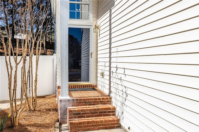 view of exterior entry with fence