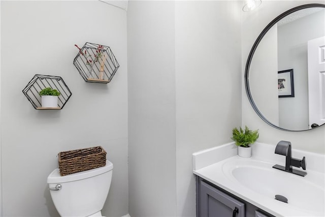 half bath with vanity and toilet