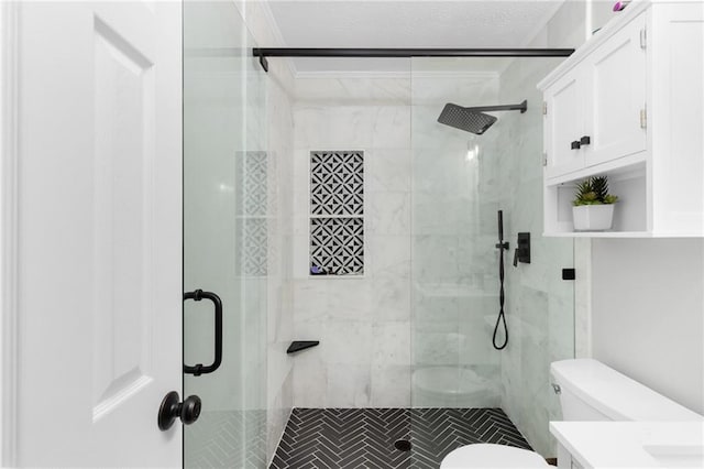 bathroom with vanity, toilet, a stall shower, and ornamental molding