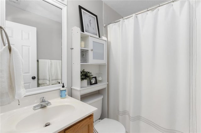 bathroom featuring toilet and vanity