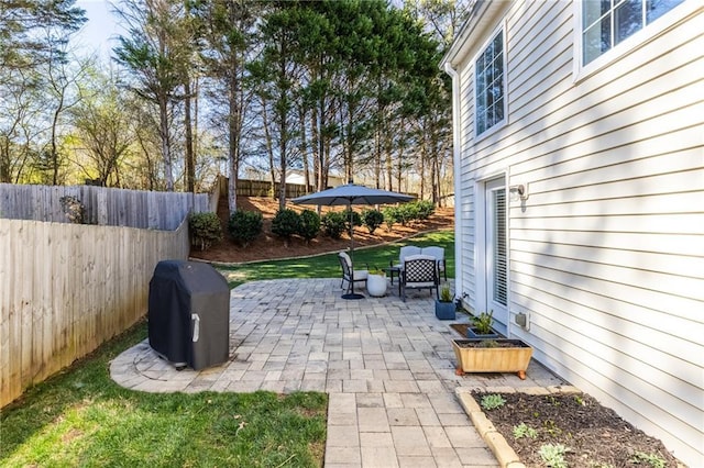 view of patio featuring grilling area and fence