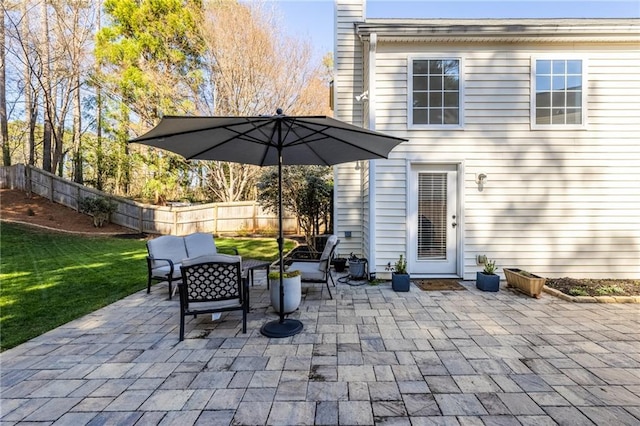 view of patio featuring an outdoor living space and fence