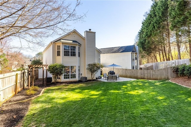 back of property with a patio area, a lawn, a fenced backyard, and a pergola