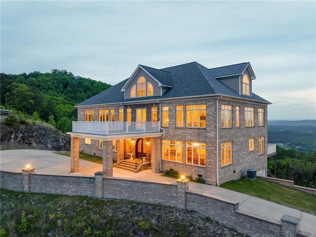 back of house with a balcony, a patio area, and central air condition unit