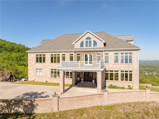 back of property featuring a balcony