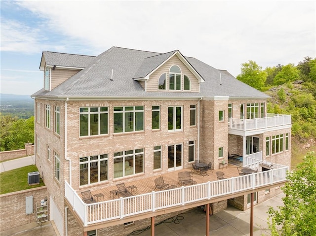 back of property featuring cooling unit and a deck