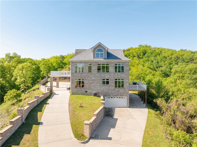 view of front of house with a garage, a front yard, central air condition unit, and a deck