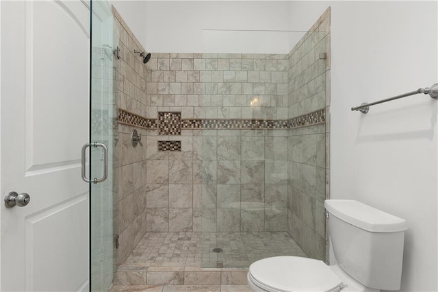 bathroom with a shower with door and toilet