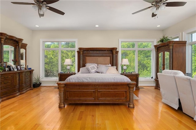 bedroom with ceiling fan and light hardwood / wood-style flooring