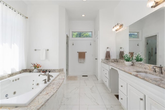 bathroom featuring vanity and separate shower and tub