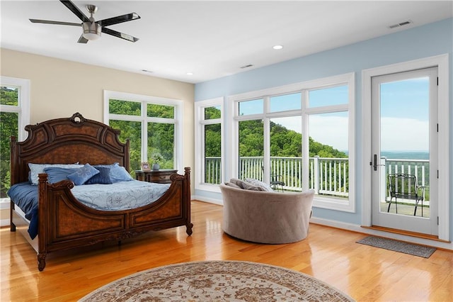 bedroom with light hardwood / wood-style flooring and access to outside