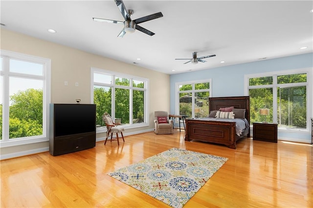 bedroom with ceiling fan and light wood-type flooring