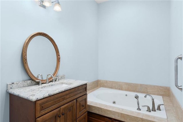 bathroom with vanity and tiled tub