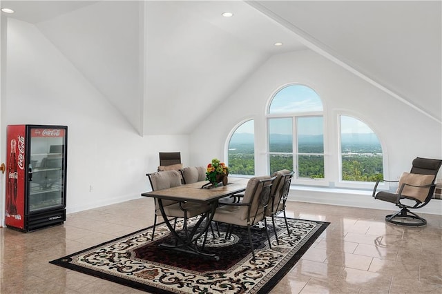 dining space with plenty of natural light and high vaulted ceiling