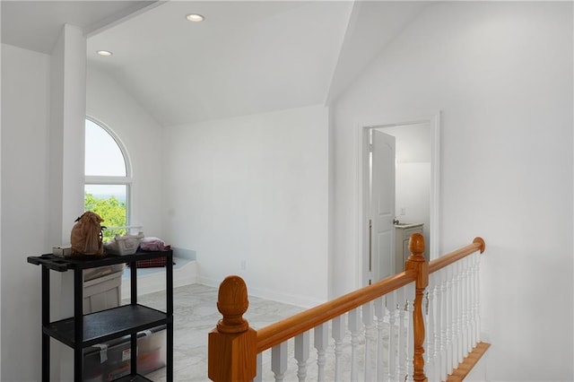 hall featuring lofted ceiling