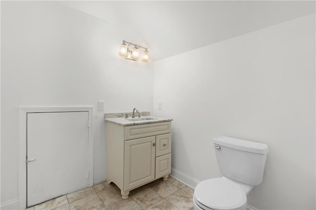 bathroom featuring vanity, tile patterned floors, toilet, and lofted ceiling