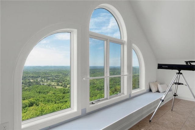 sitting room with vaulted ceiling, plenty of natural light, and light tile patterned floors