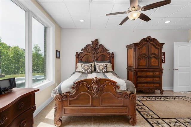 bedroom with ceiling fan and light tile patterned floors