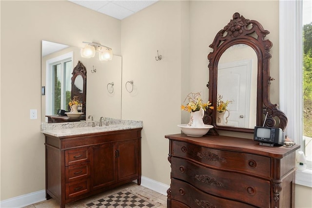 bathroom featuring tile patterned flooring and vanity