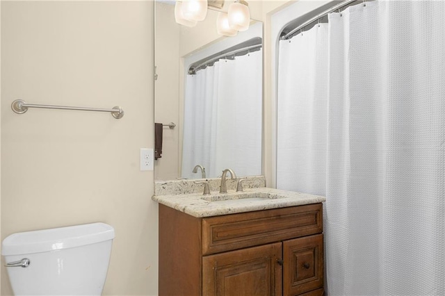 bathroom with vanity, a shower with curtain, and toilet