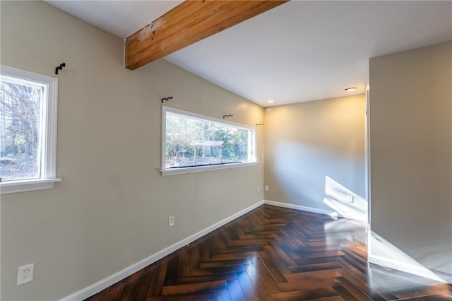 unfurnished room featuring lofted ceiling with beams and baseboards