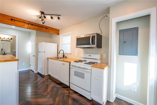 kitchen with butcher block countertops, white appliances, electric panel, and a sink