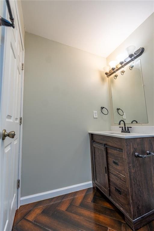 bathroom featuring baseboards and vanity