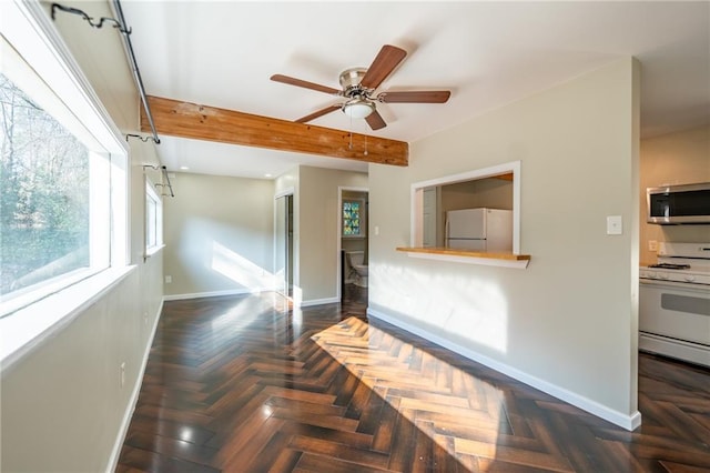 living room featuring baseboards and a ceiling fan