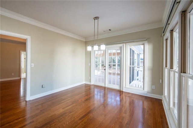 unfurnished room with crown molding, visible vents, baseboards, and wood finished floors