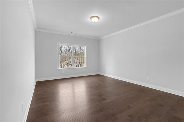 empty room featuring crown molding and dark wood-type flooring