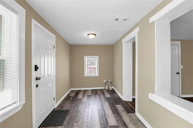 interior space featuring visible vents, baseboards, and wood finished floors