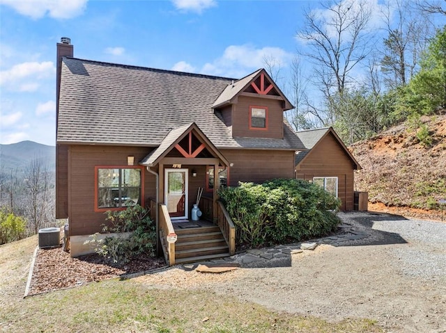 view of front of home featuring central air condition unit, a mountain view, and a porch