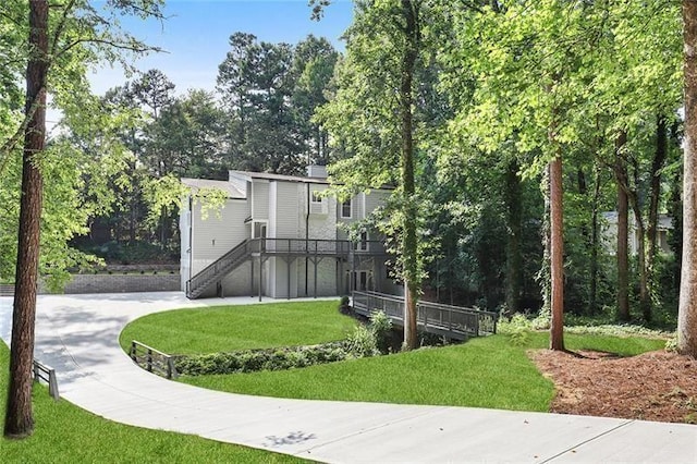 exterior space with stairway and a front yard