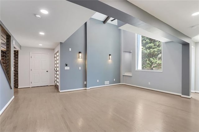 interior space featuring a fireplace, recessed lighting, wood finished floors, and baseboards