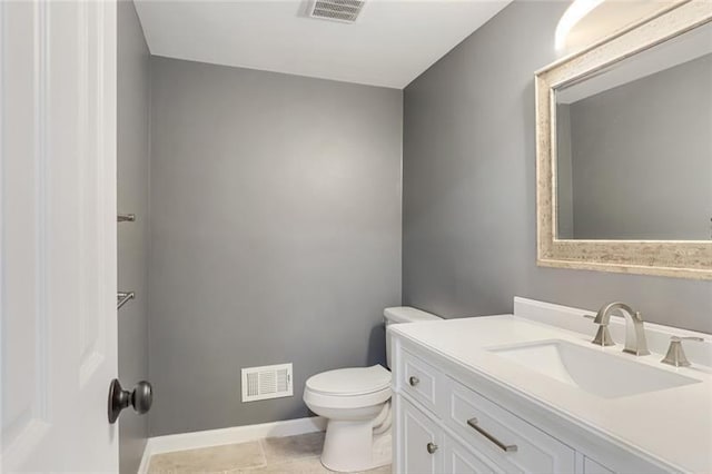 bathroom featuring visible vents, toilet, vanity, and baseboards