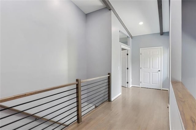 hallway with recessed lighting, baseboards, an upstairs landing, and wood finished floors