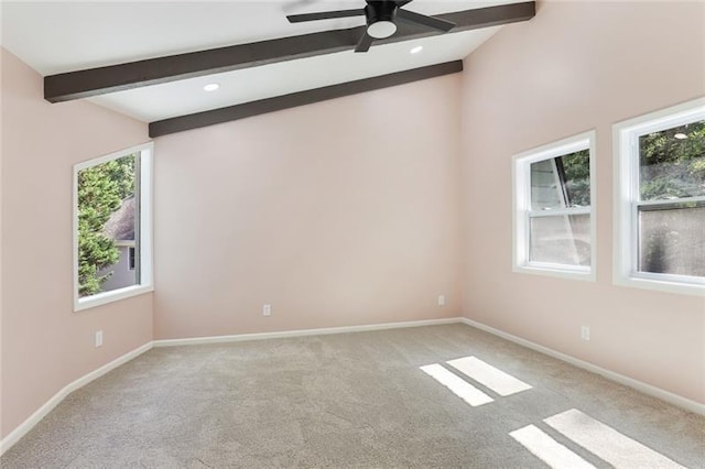 carpeted empty room featuring vaulted ceiling with beams, baseboards, and ceiling fan