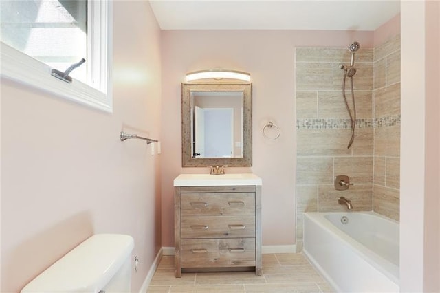 full bath with vanity, toilet, baseboards, and shower / washtub combination