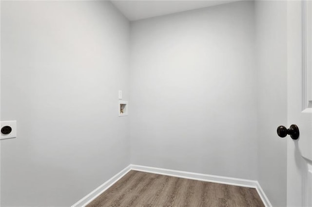 unfurnished room with baseboards and dark wood-style flooring