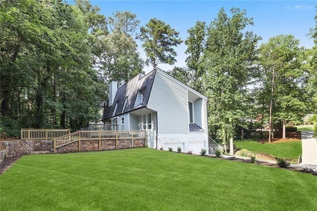 view of side of property featuring a garage, a chimney, and a yard