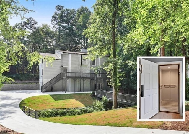 exterior space with a front yard, an outbuilding, and driveway