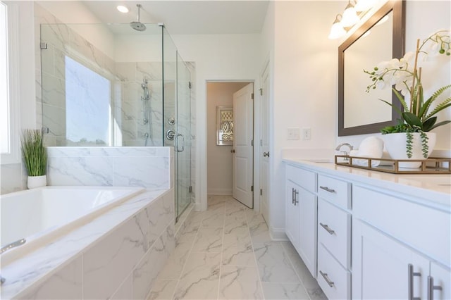 bathroom featuring vanity and independent shower and bath