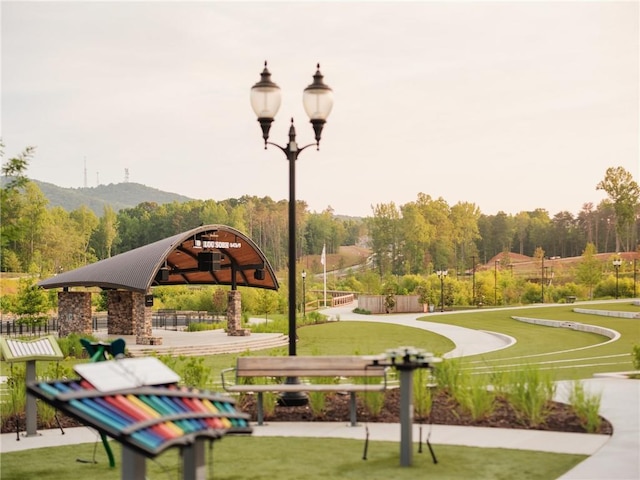 view of community featuring a yard, a mountain view, and a gazebo